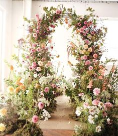 an arch made out of plants and flowers