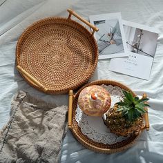 two wicker trays with pineapple on top and another basket next to them