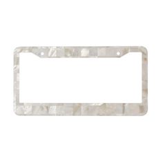 a white license plate frame with an image of a mother of pearl pattern on it