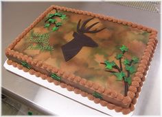 a sheet cake decorated with an image of a deer