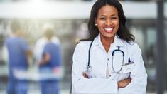 a woman doctor standing with her arms crossed