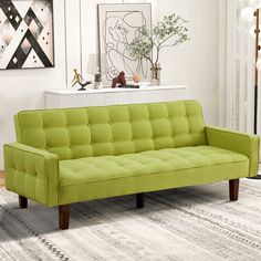 a green couch sitting on top of a white rug