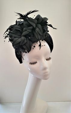 Presenting a stunning beautiful black fascinator with feathers and beading, attached via a  black velvet  covered headband  which is 4 cms in width at the widest part approximately and 3.5 cms in height (the headband) the feather flower design is much higher above the design. Perfect for special events.  If you would like the design customising at all, or an alternate colourway please get in touch with me and I will be delighted to help.   Follow us on instagram: https://www.instagram.com/designbyhummingbirdofficial/ Party Fascinator With Matching Headband And Pinched Crown, Elegant Headband Fascinator For Costume Party, Black Headband For Royal Ascot, Evening Fitted Headpiece With Handmade Flowers, Elegant Mini Hat Headband For Costume Party, Elegant Mini Hat With Headband For Costume Party, Kentucky Derby Formal Costume Headband, Black Event Headband, Adjustable Formal Costume Headband