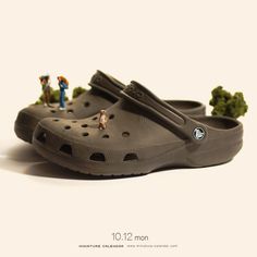 a pair of clogs with miniature people standing on them