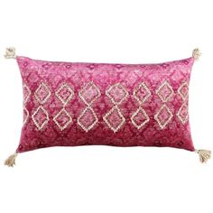 a pink and white decorative pillow with tassels