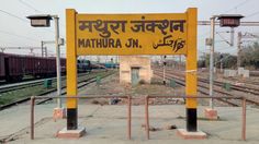 there is a sign that says mathura jn on the side of train tracks