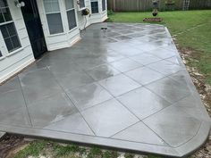 a concrete patio in front of a house