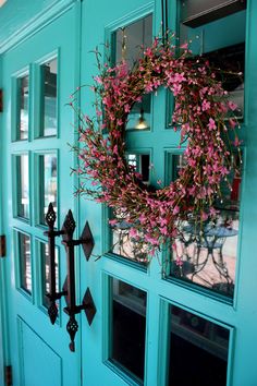 a blue door with a wreath on it