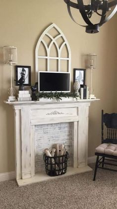 a living room with a fireplace, chair and television on top of it's mantle