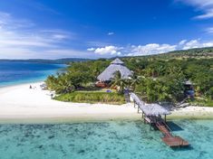 an aerial view of a tropical island with white sand and clear blue water