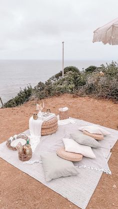 a picnic on the beach with an umbrella over it