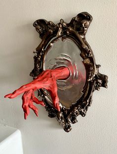 a mirror that has red hands on it