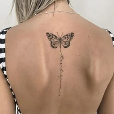 a woman with a butterfly tattoo on her back