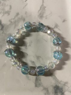 Blue bracelet with plant spacers. Crystal Bracelets Aesthetic, Bracelets Aesthetic, Bracelet Aesthetic, Blue Crystal Bracelet, Blue Forest, Jewelry Accessories Ideas, Art Practice, Accessories Ideas, Blue Bracelet