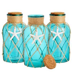 three blue glass jars with starfish decorations on them