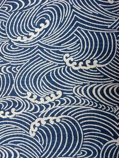 a blue and white pattern with waves on it's surface, as well as the background