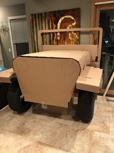 a cardboard car made to look like a carton with wheels on the front and sides