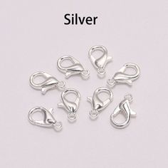 silver plated metal clasps with hooks on each side and an open loop in the middle