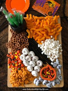 halloween snacks are arranged on a cutting board