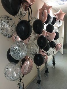 a bunch of balloons that are hanging on the wall