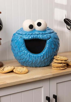 Inspired by the classic Sesame Street character, this simple jar is made of ceramic and is perfectly shaped like the big blue monster. The lid has a rubber seal around the edge, so your cookies will always stay nice and fresh! The jar measures around 12 inches tall and stores plenty of cookies, so you can bake to your heart's content! Cookie Jar Pottery, Cookie Monster Cookie Jar, Monster Bedroom, Lidded Jars Pottery, Lego Cookies, Collectible Cookie Jars, Monster Cookie, Sesame Street Cookie Monster, Blue Monster