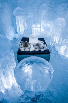 an ice hotel bed in the middle of snow