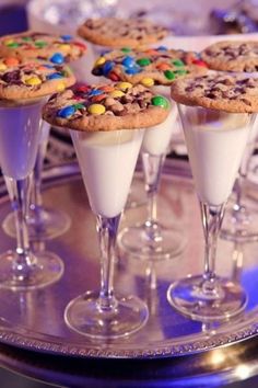 desserts are served in wine glasses on a table