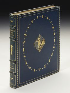 a blue book with gold trimming on the cover