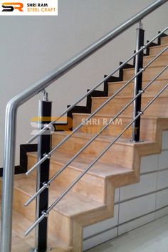 a set of stairs with metal handrails and wood treading on the bottom