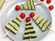 cucumber and tomato skewers are arranged on a plate