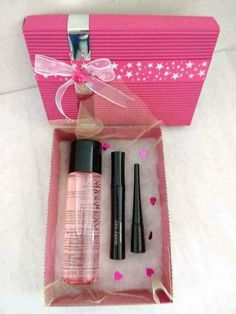 an open pink gift box with two mascaras