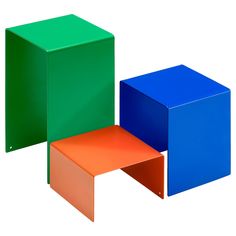 three different colored cubes sitting next to each other