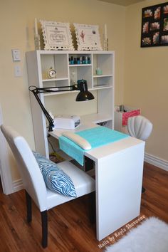 a desk and chair in a room with wood flooring next to a white bookcase