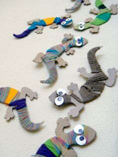 the paper lizards are all made up of different colored yarns and button holes on them