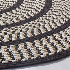 a black and white rug on the floor with two circles in front of it that have been crocheted