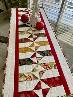 a christmas table runner with ornaments on it