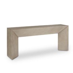 the concrete bench is made from cement and has a long, slender design on it