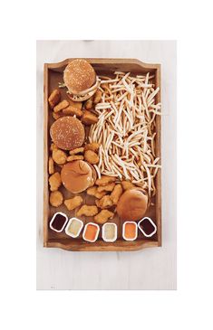 a wooden tray filled with different types of food