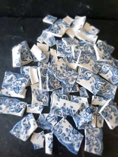 a pile of blue and white plates sitting on top of a table