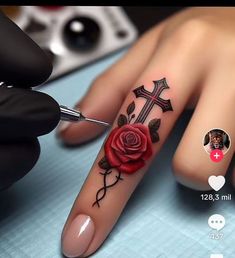 a person with a rose tattoo on their finger next to a pair of scissors and a pen