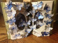 an open book with blue butterflies on it