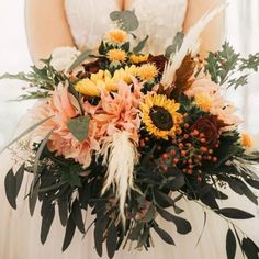 a bride holding a bouquet of flowers in her hands