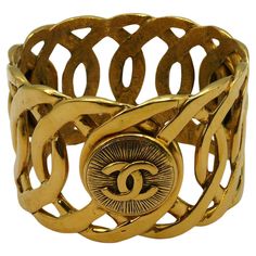 CHANEL vintage gold tone cuff bracelet featuring a rigid chain design embellished with 3 CC medallions. Slips on (no clasp). Embossed CHANEL Made in France. Indicative measurements : inner circumference approx. 21.05 cm (8.29 inches) / width approx. 4.4 cm (1.73 inches) / outer diameter approx. 6.9 cm (2.72 inches). Material : Gold tone metal hardware. NOTES - This is a preloved vintage item, therefore it might have imperfections. - Colors may differ slightly from actual product appearance due t Luxury Vintage Chain Bracelet, Luxury Vintage Gold Bracelet As A Gift, Luxury Vintage Cuff Bracelet, Luxury Vintage Cuff Bracelet For Women, Luxury Vintage Gold Bracelet Gift, Luxury Vintage Round Bracelets, Luxury Vintage Link Chain Bracelet, Vintage Yellow Gold Metal Bangle, Chanel Cuff Bracelet