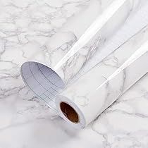 two rolls of white paper sitting on top of a marble counter