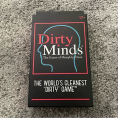 dirty minds the game of neurosity clues book laying on grey carpet with black cover