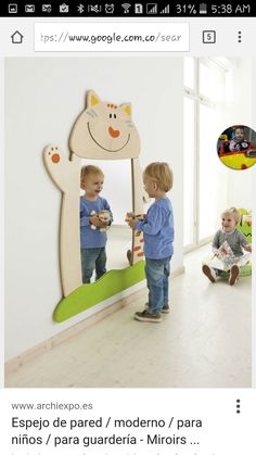 two young children are standing in front of a mirror and looking at their own reflection