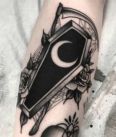 a black and white tattoo on the leg of a person