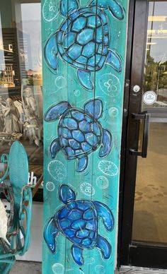 a blue snowboard with sea turtles painted on it