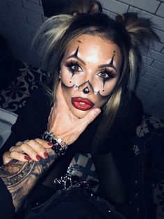 a woman with makeup on her face posing for the camera