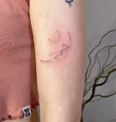 a woman's arm with a tattoo on the left side of her right arm